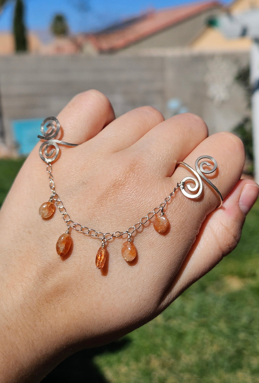 Adjustable connected sunstone rings