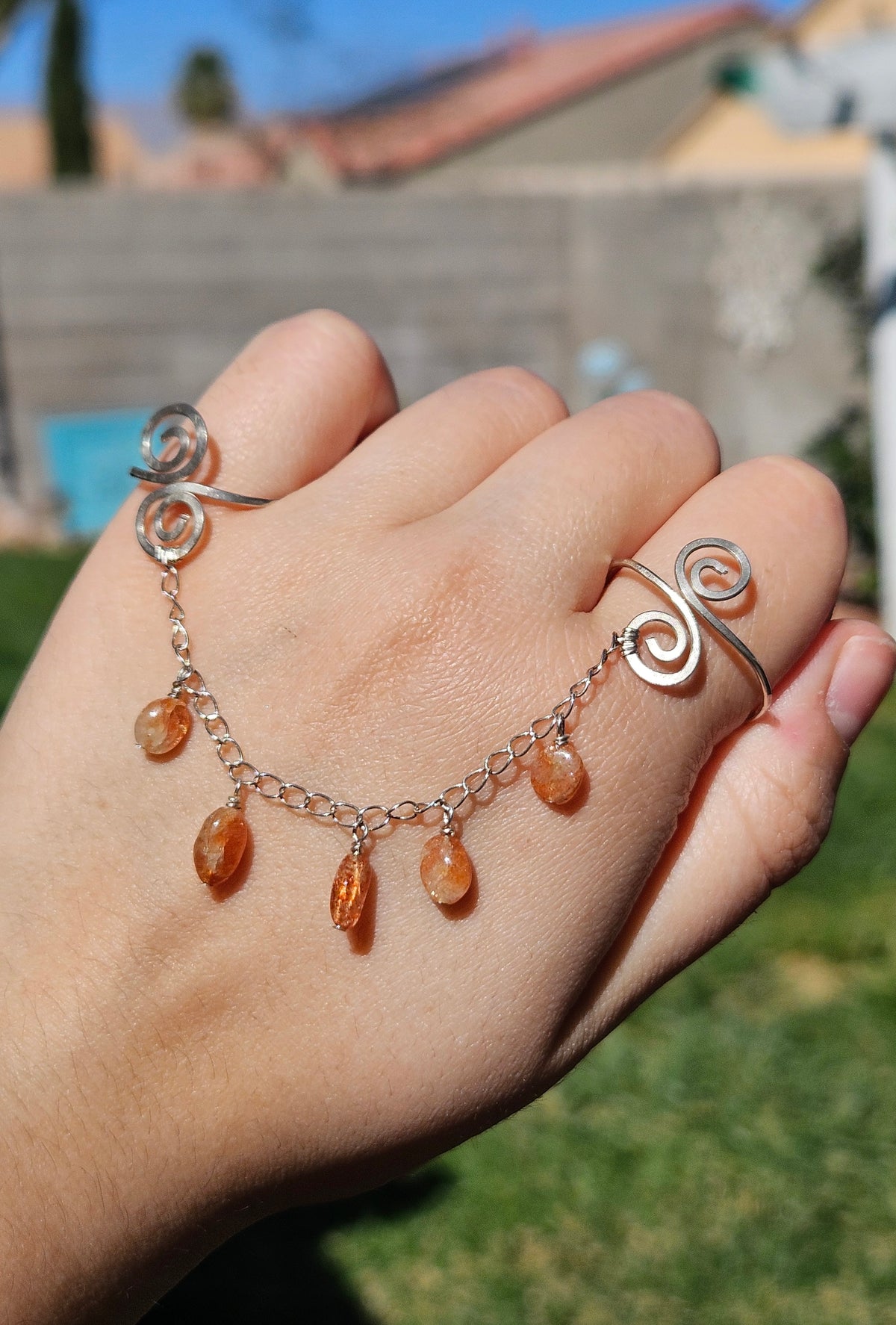 Adjustable connected sunstone rings